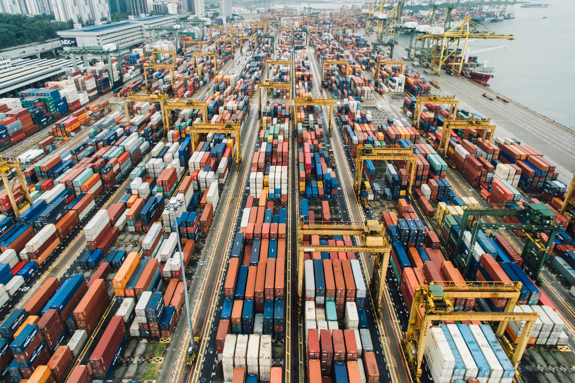 Aerial view of shipping containers and cranes at a container terminal